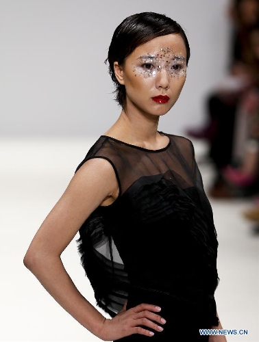 Chinese actress Wang Luodan presents a creation of Chinese designer Jenny Ji during London Fashion Week in London, Britain, on Feb. 18, 2013. (Xinhua/Tang Shi)