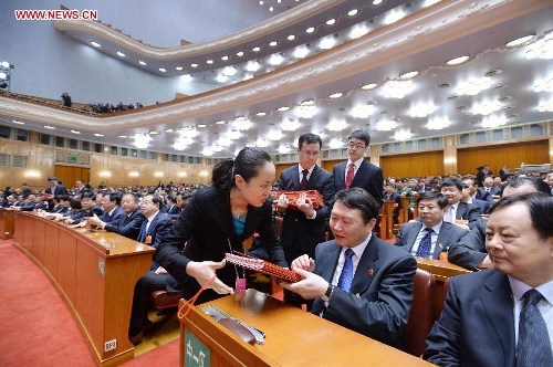  Staff members distribute ballots at the fourth plenary meeting of the first session of the 12th National People's Congress (NPC) at the Great Hall of the People in Beijing, capital of China, March 14, 2013. Chairman, vice-chairpersons, secretary-general and members of the 12th NPC Standing Committee, president and vice-president of the state, and chairman of the Central Military Commission of the People's Republic of China will be elected here on Thursday. (Xinhua/Li Tao)