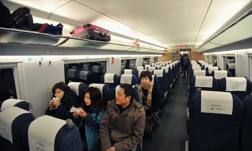 Passengers sit in high-speed train G502 at the Changsha South Railway Station in Changsha, capital of central China's Hunan Province, Dec. 26, 2012. The Changsha South Railway Station is one of the stops of the 2,298-kilometer Beijing-Guangzhou High-speed Railway, the world's longest, which was put into operation on Wednesday. Running at an average speed of 300 kilometers per hour, the high-speed railway will cut the travel time to about 8 hours from the current 20-odd hours by traditional lines between the country's capital and capital of south China's Guangdong Province. Photo: Xinhua
