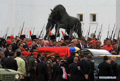 The body of late Venezuelan President Hugo Chavez is carried from the Military Academy to the Mountain Barracks, in the city of Caracas, capital of Venezuela, on March 15, 2013. Venezuelans honored late President Hugo Chavez, before his remains were transfered to the Mountain Barracks, where he will rest inside a glass case. Venezuelan President died on March 5, after struggling with cancer for two years. (Xinhua/AVN) 