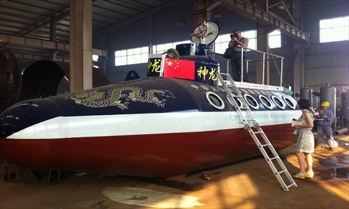 A homemade submarine, Sacred Dragon 2, sits in a factory in Fuyang, Anhui Province, awaiting the installation of an electronic system before its trial run. Its maker, Zhang Junlin, a retired police officer, said the ship can dive 50 meters underwater and can move at a speed of 15 kilometers per hour, carrying 12 passengers. Zhang's previous masterpiece, Sacred Dragon 1, was much smaller and underwent its maiden voyage in September 2010. Photo: CFP