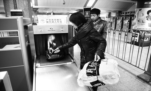 Two passengers pass through the security check at Xidan Subway Station. Photo: Li Hao/GT