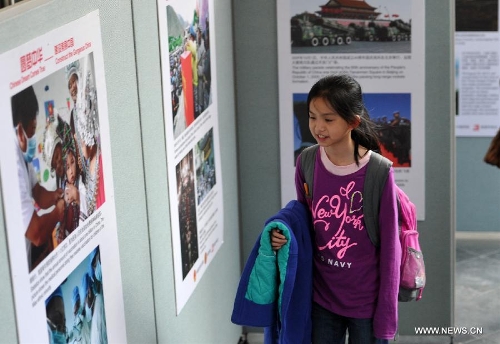  A girl views pictures at a photo exhibition named 