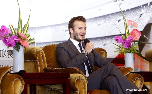Former England soccer captain David Beckham answers questions during a news conference in Shanghai, east China, June 20, 2013. Beckham arrived in China on Monday for a seven-day visit as the ambassador for the Youth Football Programme in China and China's Super League. (Xinhua/Fan Jun)