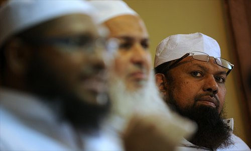 M.I.M. Rizwe (right), the Sri Lankan All Ceylon Jamiyyathul Ulama (ACJU) Mufti, speaks to reporters in Colombo on Thursday. The ACJU, Sri Lanka's main body of Islamic clergy, asked retailers to ensure products certified as 