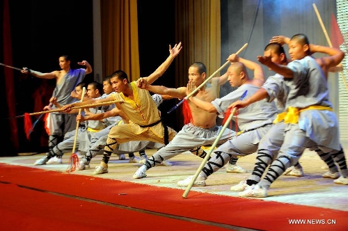 Performers of the Yandong Shaolin Kungfu troupe show their Kungfu during a performance held at the Worker's Cultural Palace, Taiyuan, capital of north China's Shanxi Province, July 6, 2013. The martial art troupe have their performers trained in the renowned Shaolin Temple, and staged performances worldwide in the hope of promoting Shaolin-style martial arts and Chinese culture. (Xinhua/Fan Minda)&nbsp; 