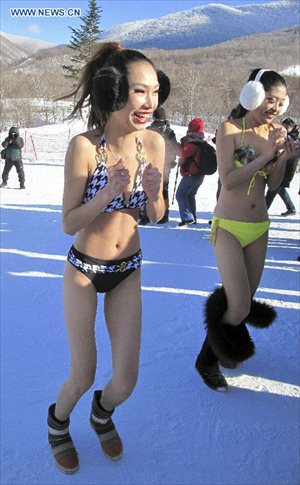 Models present bikini collections during a ski performance held in Beidahu ski resort of Jilin City, northeast China's Jilin Province, December 31, 2012. Some 40 models in G-strings and bras shivered from the cold as they showed off on snow-covered slopes in the ski resort to promote the event.Photo: Xinhua 