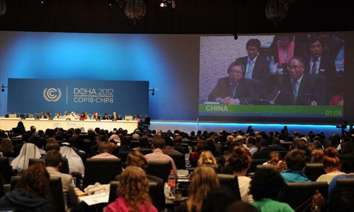 Xie Zhenhua (R, on screen), head of the Chinese delegation to Doha climate talks, makes a statement after the passing of the final agreements of the UN Climate Change Conference (COP 18/CMP 8) at the Qatar National Convention Center (QNCC) in Doha, Qatar, December 8, 2012. Photo: Xinhua