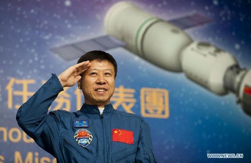 Astronaut Liu Wang salutes at a press conference in South China's Hong Kong, August 10, 2012. A 40-plus-member delegation of Tiangong-1/Shenzhou-9 Manned Space Docking and Rendezvous Mission, including three astronauts who had fulfilled China's first manned space docking mission this June, arrived at Hong Kong Friday for a four-day visit. Photo: Xinhua