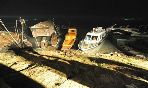 Photo taken on October. 5, 2012 shows a dock near the accident site where two ships collided on Yuanjiang River in Yuanjiang City, central China's Hunan Province. At least eight people died and another four remained missing after two ships collided Friday afternoon on the Yuanjiang River. Searching efforts for the missing people are going on. The cause of the accident is under investigation. Photo: Xinhua