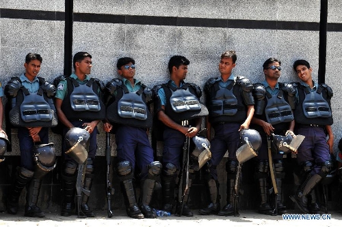 Police stand guard in a street during a grand rally at Motijheel area in Dhaka, Bangladesh, April 6, 2013. Tens of thousands of Islamists under the banner of Hefazat-e-Islam from across Bangladesh poured into the key commercial hub of the capital city to join a grand rally, demanding action against the 