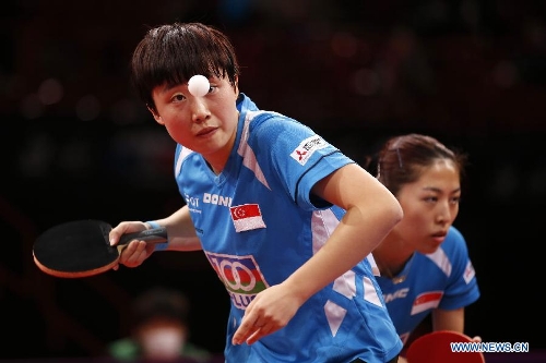 Feng Tianwei (L) and Yu Mengyu of Singapore compete during the semifinal of women's doubles against Guo Yue and Li Xiaoxia of China at the 2013 World Table Tennis Championships in Paris, France on May 19, 2013. Feng and Yu lost 2-4. (Xinhua/Wang Lili) 
