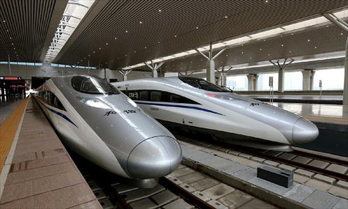 Trains wait to leave for Beijing at Zhengzhou East Railway Station in Zhengzhou City, capital of central China's Henan Province, November 25, 2012. The high-speed rail route from Beijing to the southern Chinese city of Guangzhou will open next month, cutting the 2,200-km journey time by 14 hours, according to the Ministry of Railways. A trial operation along the Beijing-Zhengzhou section, the last part of the route, began on Sunday morning. Photo: Xinhua