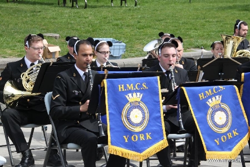 A band from Canada Navy plays at the Toronto Zoo in Toronto, Canada, on May 18, 2013. Er Shun and Da Mao, the two giant pandas on a 10-year loan from China, made their first public appearance in their new home at the Toronto Zoo on Saturday. (Xinhua/Zhang Ziqian) 