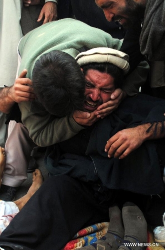 A Pakistani villager from Bara mourns over the death of his relative during a protest in northwest Pakistan's Peshawar on Jan. 16, 2013. Demonstrators said gunmen wearing military uniforms stormed homes in Bara Tehsil in Khyber Agency, some 30 kilometers from Peshawar, and shot 18 villagers dead in an overnight raid. (Xinhua/Umar Qayyum) 
