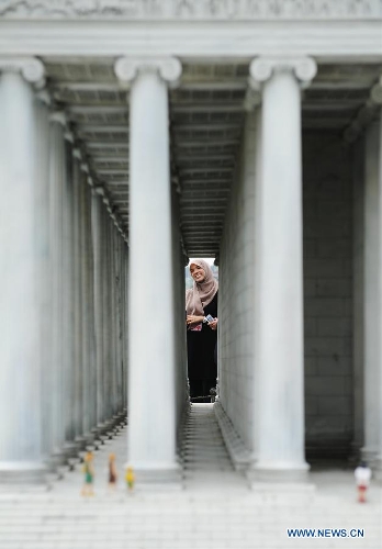 A visitor looks at the miniature of Temple of Artemis in the Miniature park in Istanbul, Turkey, on May 11, 2013. The Miniaturk park is the first miniature park in Istanbul and has welcomed 6.5 million visitors over the past 10 years. (Xinhua/Lu Zhe) 