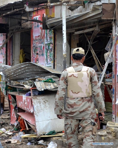 A Pakistani soldier inspects the blast site in southwest Pakistan's Quetta, April 24, 2013. At least four people were killed and 37 others injured on Tuesday night in a series of bomb blasts followed by a suicide attack in Pakistan's southwestern provincial capital of Quetta, local media reported. (Xinhua/Mohammad)