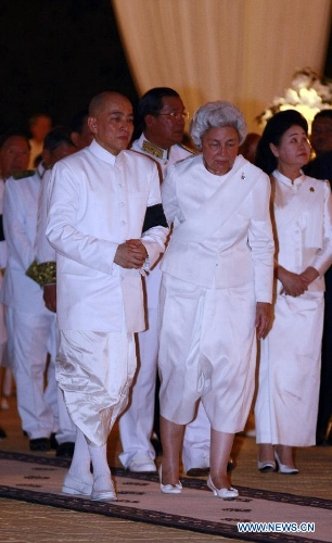 Cambodia's Queen Mother Norodom Monineath Sihanouk (R, front) and King Norodom Sihamoni (L, front) leave the cremation site next to the royal palace in Phnom Penh, Cambodia, Feb. 4, 2013. Cambodia began to cremate the body of the country's most revered King Father Norodom Sihanouk on Monday evening after it had been lying in state for more than three months at the capital's royal palace. (Xinhua/Sovannara) 