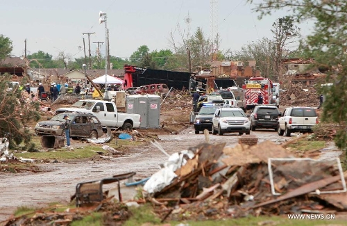 Rescuers and residents clean up a destroyed neighborhood in Moore, Oklahoma, May 21, 2013, one day after a tornado moved through. A powerful tornado attacked on Monday afternoon the southern suburbs of the Oklahoma City, capital of the U.S. state of Oklahoma, killing at least 24 people, including 9 children. (Xinhua/Song Qiong)