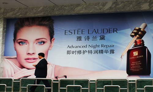 A man passes a billboard for a cosmetic maker in Yichang, Hubei Province, Thursday. The cosmetics industry spent more on advertising in 2012 than any other industry in China, according to the results of a recent survey by Tsinghua University. Photo:CFP