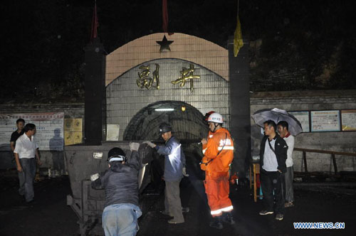 Rescuers work at the accident site of Guba Coal Mine in Longchang Township of Fuquan City, southwest China's Guizhou Province, September 12, 2012. A coal mine flooding happened here at about 11:30 pm Tuesday, when 41 miners were working underground. Eight miners were trapped in the coal mine. The rescue operation is under way. Photo: Xinhua