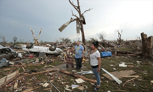 Philip Gotcher and his daughter Monica stand in the rubble of his house after a powerful tornado ripped through the area on Monday in Moore, Oklahoma. The tornado, reported to be at least EF4 strength and two miles wide, touched down in the Oklahoma city area on Monday killing at least 24 people. Photo: AFP