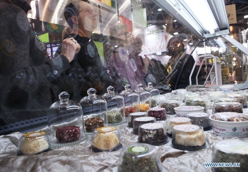 Customers buy cheese products at the International Hospitality and Food Service Fair (SIRHA) in Lyon, France, on Jan. 30, 2013. The five-day fair was closed on Wednesday. The biyearly SIRHA was founded in 1984 and is considered one of the most influential food expos in Europe. (Xinhua/Gao Jing)
