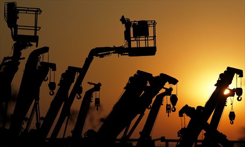 Cranes and boom lifts stand at an equipment rental company near a construction site in Tokyo, Japan, on Tuesday. Prime Minister Shinzo Abe aims to compile Japan's economic stimulus package on Friday, and seeks to have a new economic growth strategy by mid-year. Photo: CFP