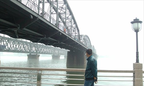A man gazes across the Yalu River Bridge, which separates China's Dandong and North Korea's Sinuiju, on May 29. Photo: Liang Chen/GT