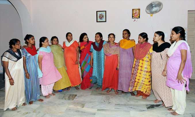 Indian surrogate mothers pose with Dr Nayna Patel (sixth from left) at a 