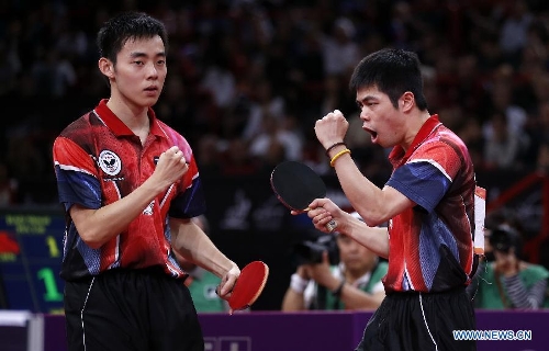 Chen Chien-An and Chuang Chih-Yuan (R) of Chinese Taipei celebrate during the final of men's doubles against Hao Shuai and Ma Lin of China at the 2013 World Table Tennis Championships in Paris, France on May 19, 2013. Chen and Chuang won 4-2. (Xinhua/Wang Lili) 