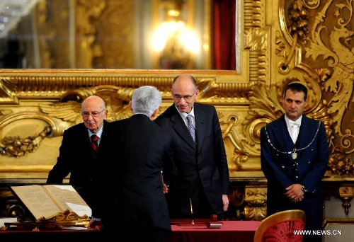Italian Prime Minister Enrico Letta shakes hands with a new cabinet member at the swearing-in ceremony in Rome, Italy, on April 28, 2013. Italy's new cabinet, lead by Prime Minister Enrico Letta, was sworn in on Sunday, starting their task for breaking the impasse the country had been locked for months. (Xinhua/Xu Nizhi)  