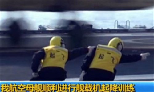 Many Chinese Web users pose for photos of themselves imitating air traffic ground control workers. The trend came in the excitement that followed Chinese media reports of the successful takeoffs and landings of China's home-made fighters on the Liaoning, China's first aircraft carrier. Photo: CFP, Weibo 