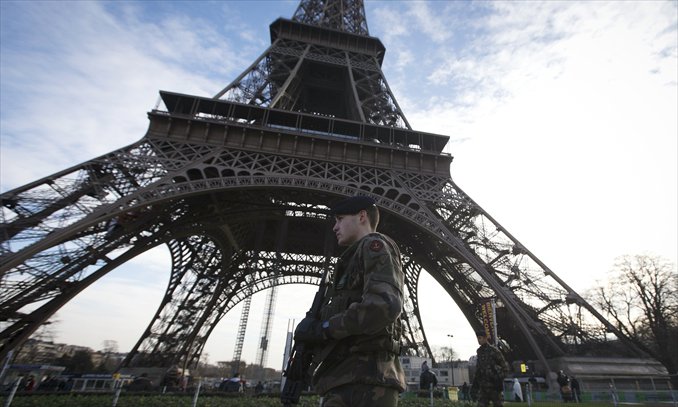 Soldiers patrol under the Eiffel Tower on Monday in Paris. Islamist forces based in northern Mali vowed Monday to avenge France's fierce military offensive against them on French soil (see story on page 8). Photo: AFP