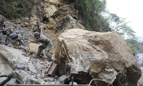 Soldiers from the People's Liberation Army (PLA) Chengdu Military Area Command (MAC) clear a path in Baoxing county, which was cut off by a landslide on April 23. Photo: Li Hao/GT