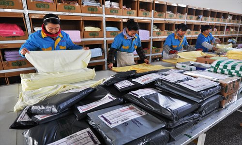 Workers pack products to be delivered for online orders in Zouping, East China's Shandong Province, on Thursday. Photo: CFP