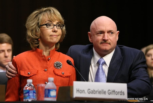 Former U.S. Rep. Gabby Giffords (L) who is a shooting victim, accompanied with her husband Navy Capt. Mark Kelly deliveries an opening statement during the hearing for a Senate Judiciary Committee about gun control on Capitol Hill in Washington D.C., the United States, Jan. 30, 2013. (Xinhua/Fang Zhe) 