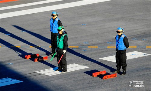 Photo shows crew members of China's first aircraft carrier, the Liaoning, wearing waistcoats of different colors, which indicate their different works. Photo: mil. cnr.cn