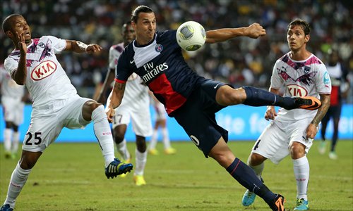 Paris Saint-Germain's Swedish forward Zlatan Ibrahimovic (center) kicks the ball under pressure from Bordeaux's Brazilian defender Ferreira Mariano (left) during the Champions Trophy match on Saturday. Photo: AFP