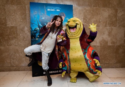 Aerosmith singer Steven Tyler poses for photos with a character of movie 