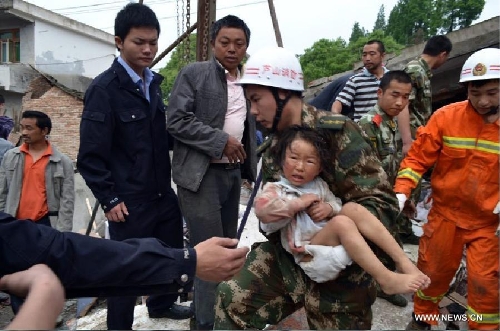 Firemen rescue a girl from debris in Lushan County of Ya'an City, southwest China's Sichuan Province, April 20, 2013. At least 113 people have been killed in the 7.0-magnitude earthquake in Sichuan Province as of 4:40 p.m. on Saturday, according to the provincial seismological bureau. (Xinhua)
