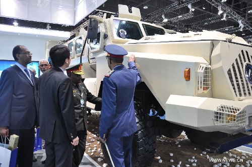 People visit the MRAP Type CS/VP3 displayed by China' defense giant China Poly Group Corp. during the Defense Exhibition and Conference (IDEX) 2013 in Abu Dhabi, the United Arab Emirates, Feb. 18, 2013. (Xinhua) 