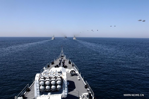 Helicopters fly over a naval ship during the AMAN-13 exercise in the Arabian Sea, March 8, 2013. Naval ships from 14 countries, including China, the United States, Britain and Pakistan, joined a five-day naval drill in the Arabian Sea from March 4, involving 24 ships, 25 helicopters, and special forces. (Xinhua/Rao Rao) 