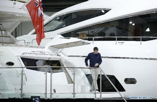 A visitor goes aboard a yacht on display at the 58th London Boat Show, held at the ExCeL Exhibition and Convention Centre in London, Jan. 14, 2013. The 58th London Boat Show showcases, demonstrates and sells maritime equipments including luxury yachts, dinghies, boating equipment and clothing with interactive sections and features attractions devoted to boating until Jan. 20, 2013. (Xinhua/Wang Lili) 