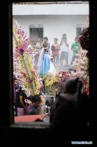 Residents participate in the procession of 