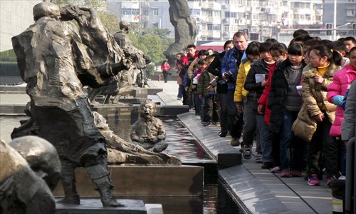 Citizens in Nanjing, Jiangsu Province line up to pay tribute to the deceased of the Nanjing Massacre in front of the city's memorial hall. Photo: CFP