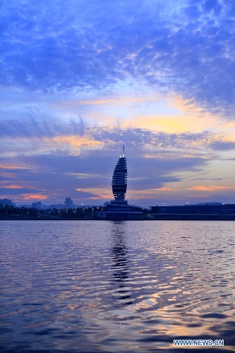 A tower is seen under colorful sunset glow in Rizhao, east China's Shandong Province, May 16, 2013. (Xinhua/Li Xiaolong)&nbsp; 