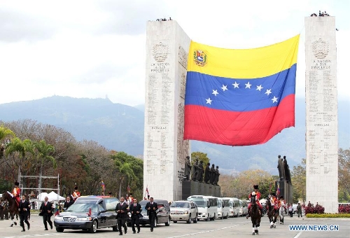 The body of late Venezuelan President Hugo Chavez is carried from the Military Academy to the Mountain Barracks, in the city of Caracas, capital of Venezuela, on March 15, 2013. Venezuelans honored late President Hugo Chavez, before his remains were transfered to the Mountain Barracks, where he will rest inside a glass case. Venezuelan President died on March 5, after struggling with cancer for two years. (Xinhua/AVN) 