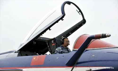 A maintenance staff member of Bayi Aerobatic Team of the People's Liberation Army (PLA) Air Force, checks a plane in Zhuhai, south China's Guangdong Province, November 12, 2012. The 9th China International Aviation and Aerospace Exhibition will kick off on Tuesday in Zhuhai. Photo: Xinhua