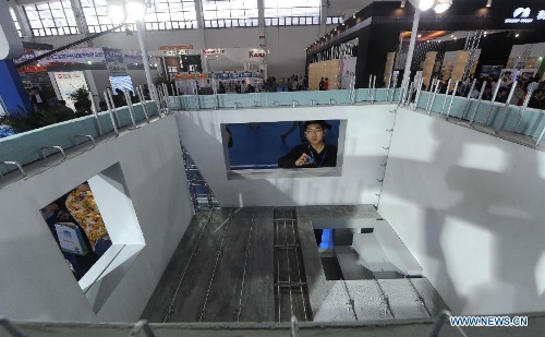 A man visits an architecture model during the 2013 China (Shenyang) International Architecture Exposition in Shenyang, capital of northeast China's Liaoning Province, May 20, 2013. The three-day expo kicked off on Monday, with 615 enterprises from home and abroad participated. (Xinhua/Yang Qing)